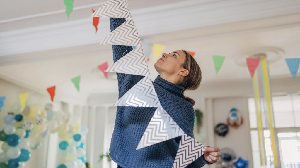 A women hanging up party decorations